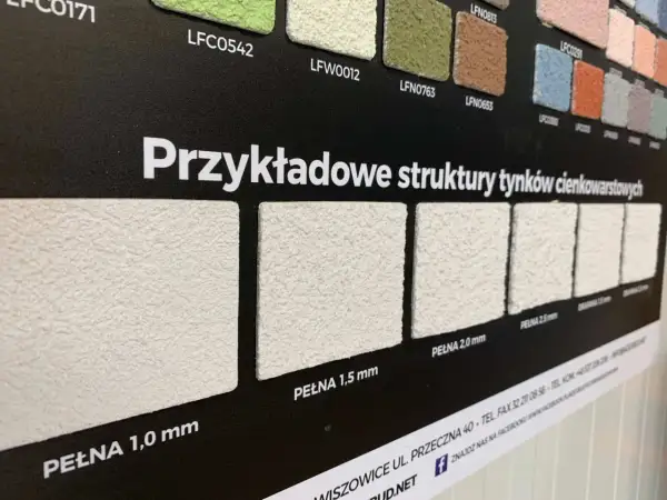 Próbki tynków elewacyjnych o różnych fakturach i grubościach ziarna.